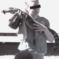 G: A reptile’s mouth has been taped shut in order to be used for photographs Sterling & Reid Circus.